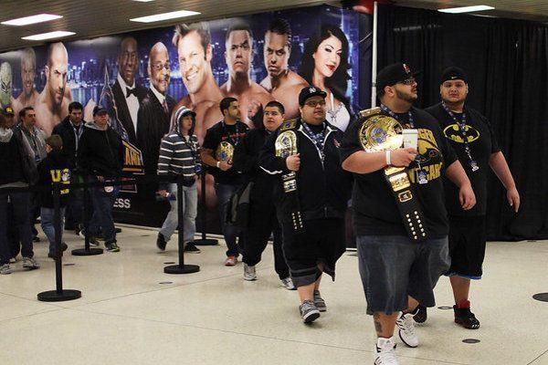 Fan with replica Money in the Bank briefcase “cashes in” on fan with replica championship belt